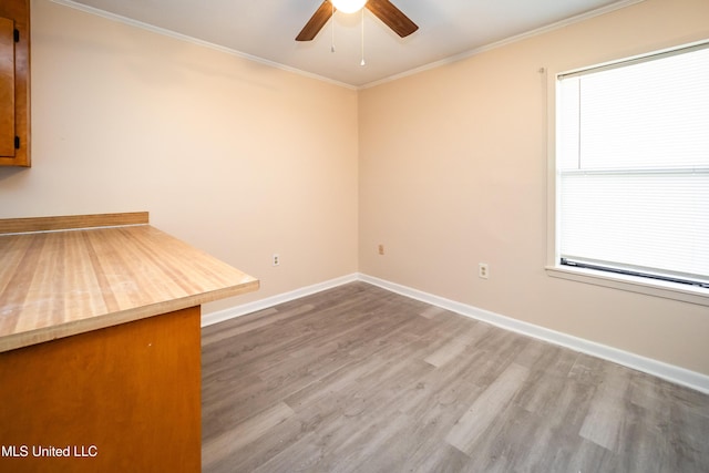 unfurnished room with hardwood / wood-style flooring, ceiling fan, and ornamental molding