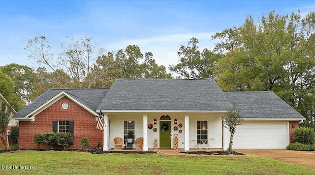 view of front facade featuring a garage, a front yard, and covered porch