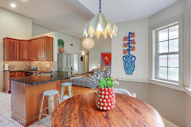 dining area with a healthy amount of sunlight, light tile patterned floors, and sink