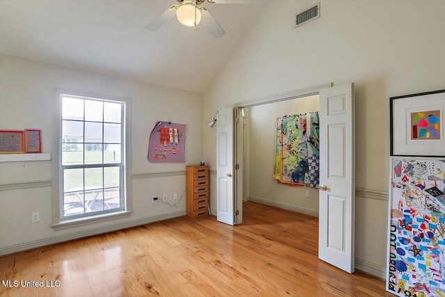 bedroom with high vaulted ceiling, light hardwood / wood-style flooring, and ceiling fan