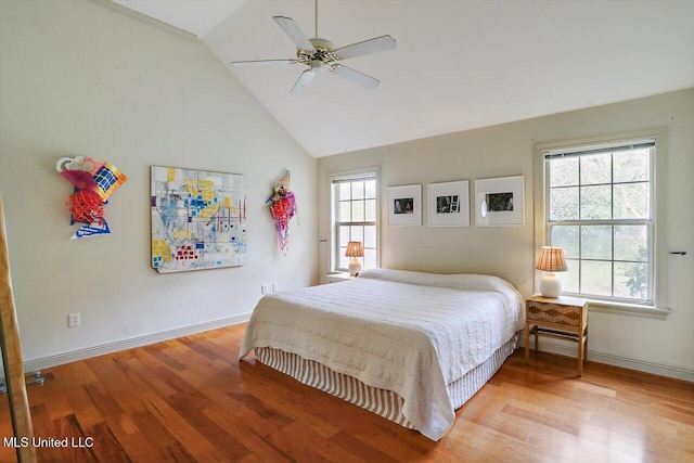 bedroom with light wood-type flooring, multiple windows, lofted ceiling, and ceiling fan