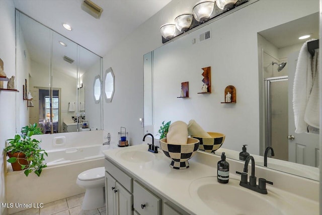 full bathroom featuring shower with separate bathtub, toilet, vaulted ceiling, tile patterned flooring, and vanity