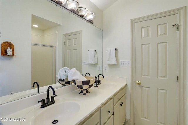 bathroom featuring walk in shower and vanity