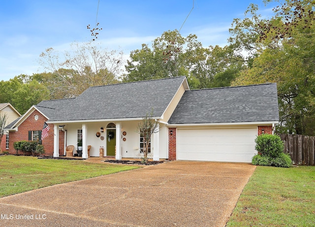 view of front of property featuring a garage, a porch, and a front lawn