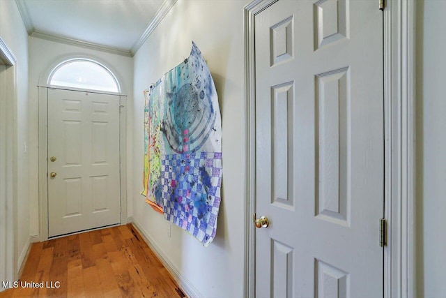 entryway featuring ornamental molding and light hardwood / wood-style flooring