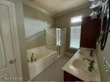 bathroom with vanity, crown molding, and shower with separate bathtub