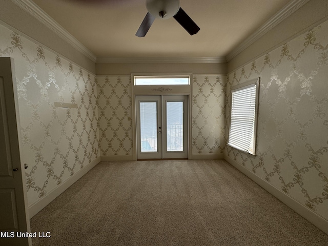 carpeted spare room featuring crown molding, french doors, and ceiling fan