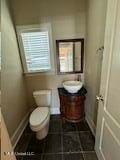 bathroom featuring toilet, vanity, and tile patterned floors