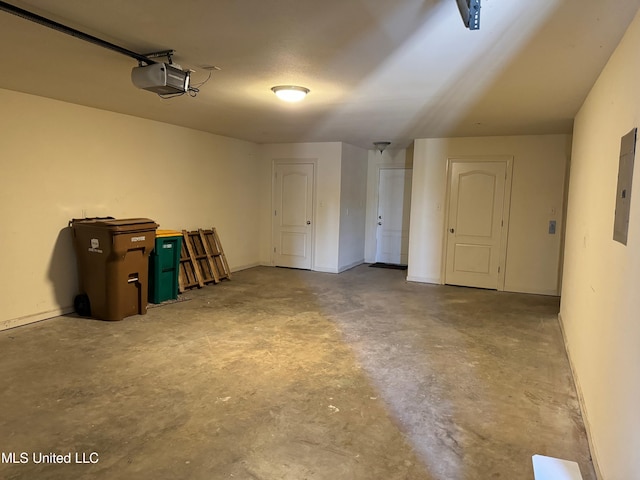 garage with a garage door opener and electric panel