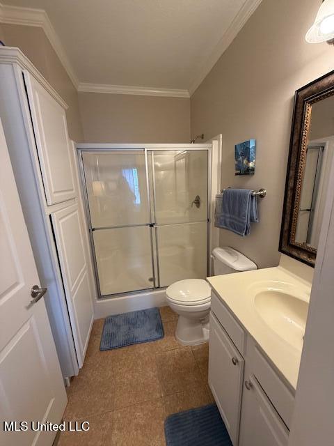 full bathroom featuring toilet, ornamental molding, a shower stall, and vanity