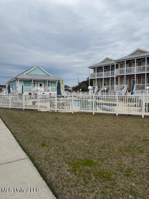 surrounding community with fence and a lawn