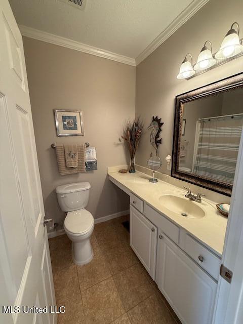 full bathroom featuring baseboards, toilet, tile patterned floors, crown molding, and vanity