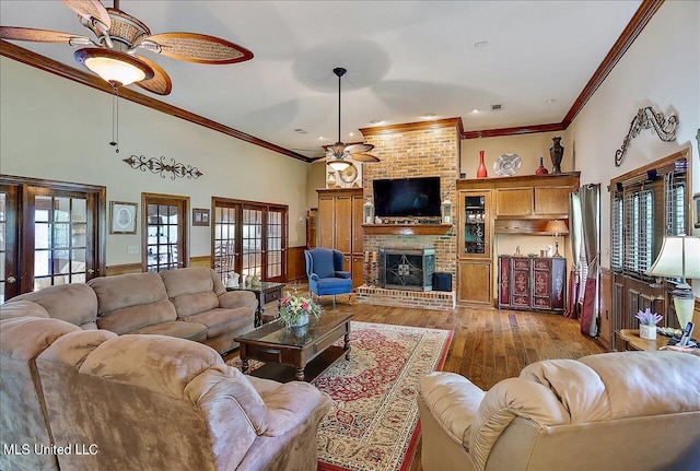 1600 Pine Hill Dr, Raymond, MS 39154 - living room featuring a ceiling fan, light wood-style floors, ornamental molding, a brick fireplace, and a towering ceiling