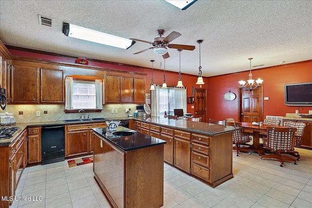 kitchen featuring sink, light tile patterned floors, a center island, and pendant lighting