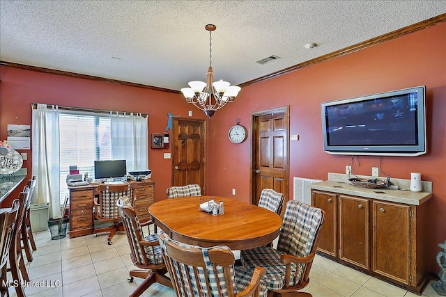 tiled dining space with crown molding, a textured ceiling, and a notable chandelier