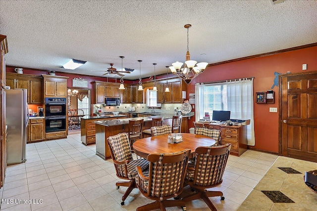 dining area with light tile patterned floors, a textured ceiling, ceiling fan with notable chandelier, crown molding, and sink