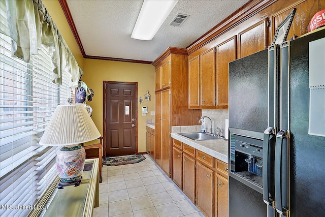 1600 Pine Hill Dr, Raymond, MS 39154 - clothes washing area featuring a sink, light tile patterned flooring, crown molding, and a textured ceiling