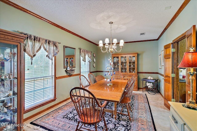 carpeted dining space with ornamental molding, a textured ceiling, and a chandelier