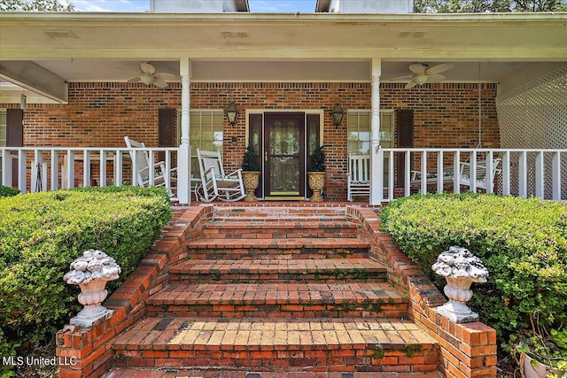 entrance to property featuring a porch and ceiling fan