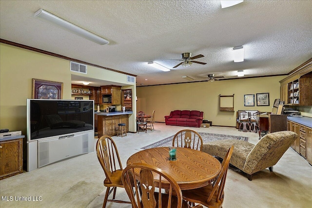 1600 Pine Hill Dr, Raymond, MS 39154 - dining room with light carpet, a ceiling fan, a textured ceiling, and ornamental molding