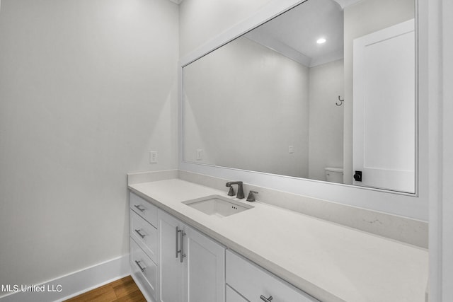 54 Windermere Blvd, Madison, MS 39110 - bathroom with baseboards, vanity, wood finished floors, and toilet