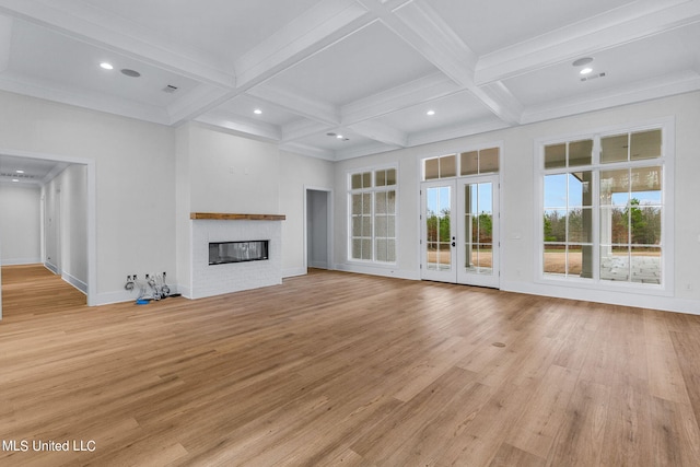 54 Windermere Blvd, Madison, MS 39110 - unfurnished living room with light wood-style floors, beam ceiling, coffered ceiling, a glass covered fireplace, and recessed lighting