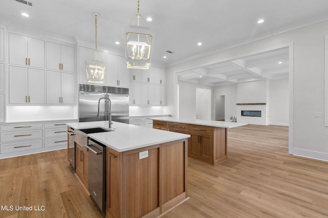54 Windermere Blvd, Madison, MS 39110 - kitchen with a kitchen island with sink, appliances with stainless steel finishes, light wood finished floors, recessed lighting, and beam ceiling