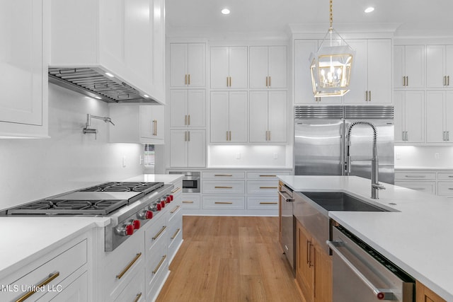 54 Windermere Blvd, Madison, MS 39110 - kitchen featuring stainless steel appliances, a sink, light countertops, light wood finished floors, and white cabinetry