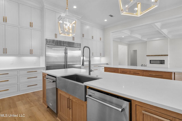 54 Windermere Blvd, Madison, MS 39110 - kitchen with appliances with stainless steel finishes, a chandelier, a sink, beam ceiling, and light wood-style flooring