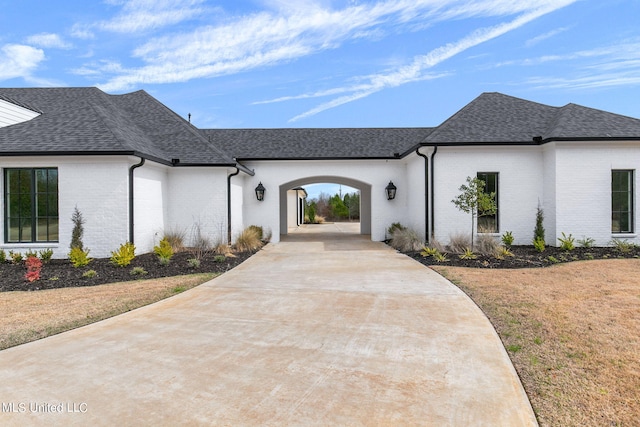 54 Windermere Blvd, Madison, MS 39110 - french country inspired facade featuring roof with shingles, brick siding, a front yard, and concrete driveway