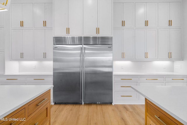 54 Windermere Blvd, Madison, MS 39110 - kitchen featuring built in fridge, light wood finished floors, and light countertops