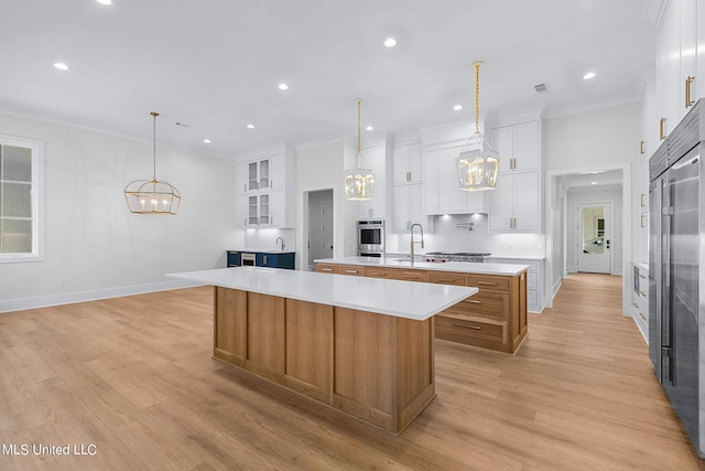 54 Windermere Blvd, Madison, MS 39110 - kitchen with a spacious island, a chandelier, a sink, appliances with stainless steel finishes, and light countertops