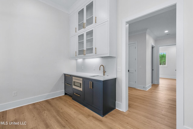 54 Windermere Blvd, Madison, MS 39110 - bar area featuring a sink, ornamental molding, stainless steel microwave, baseboards, and light wood-type flooring