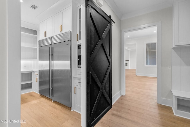 54 Windermere Blvd, Madison, MS 39110 - kitchen featuring built in fridge, a barn door, light wood-style flooring, recessed lighting, and crown molding