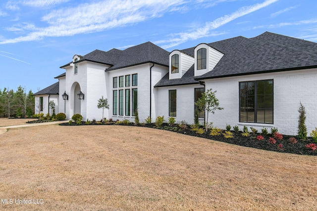 54 Windermere Blvd, Madison, MS 39110 - french country inspired facade featuring brick siding, roof with shingles, and a front yard