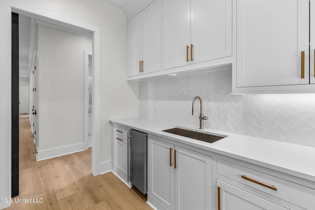 54 Windermere Blvd, Madison, MS 39110 - kitchen featuring a sink, light countertops, tasteful backsplash, light wood-style floors, and white cabinets