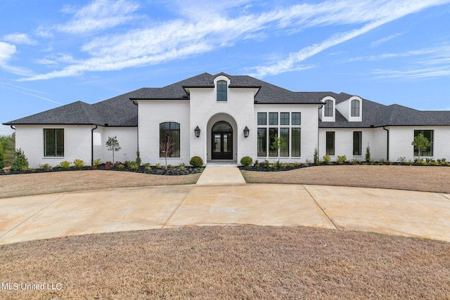 54 Windermere Blvd, Madison, MS 39110 - french country inspired facade featuring french doors, roof with shingles, and brick siding
