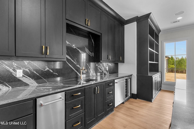 54 Windermere Blvd, Madison, MS 39110 - kitchen with dark cabinets, decorative backsplash, ornamental molding, dark stone counters, and light wood-type flooring