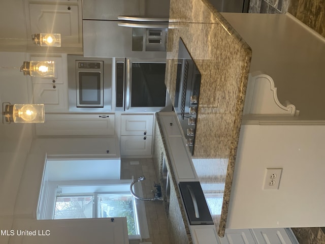 kitchen featuring white cabinets