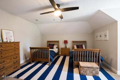 carpeted bedroom featuring ceiling fan and vaulted ceiling