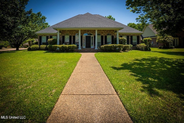 view of front of home with a porch and a front yard