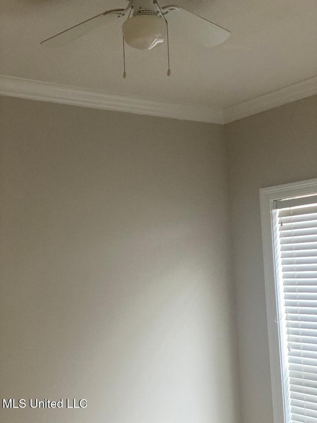 empty room with crown molding and ceiling fan