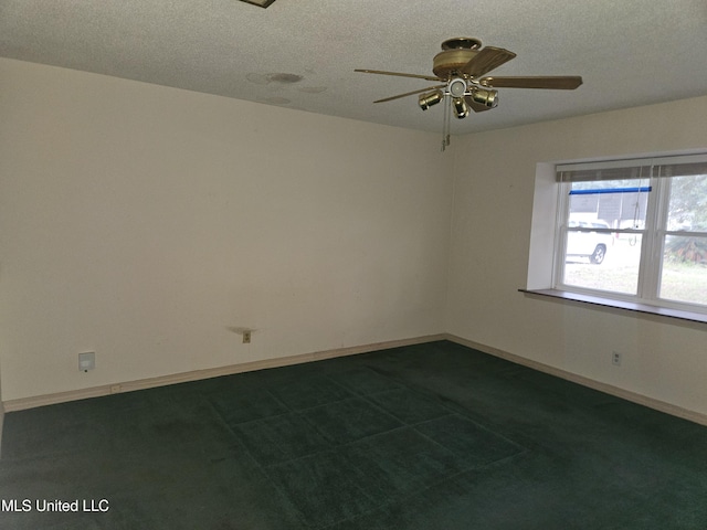 carpeted empty room featuring ceiling fan and a textured ceiling