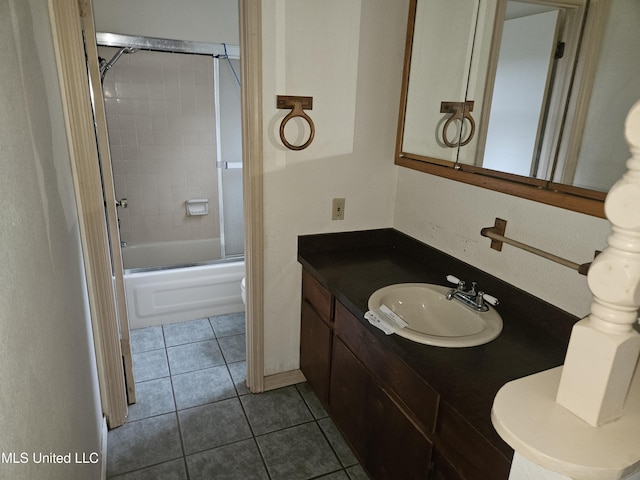 full bathroom with bath / shower combo with glass door, toilet, vanity, and tile patterned flooring