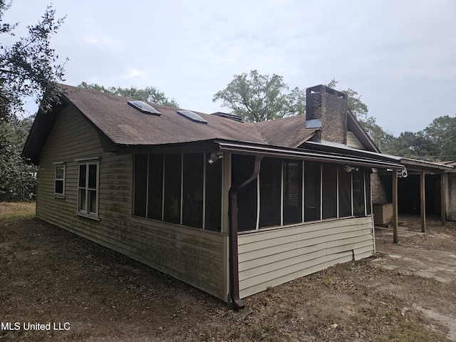 view of side of home featuring a sunroom