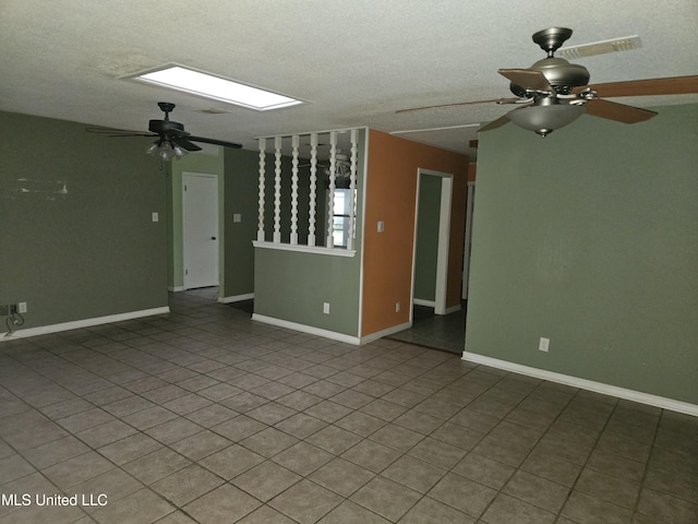 unfurnished room featuring a textured ceiling and tile patterned flooring