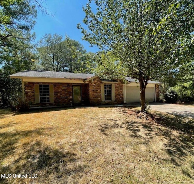 637 Chelsea Dr, Jackson, MS 39212 - single story home with an attached garage, concrete driveway, and a front lawn