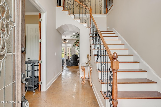 2550 Jones Rd, Terry, MS 39170 - tiled foyer featuring ceiling fan, stairway, french doors, a towering ceiling, and ornamental molding
