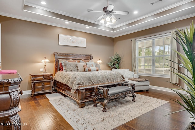 2550 Jones Rd, Terry, MS 39170 - bedroom with ornamental molding, a tray ceiling, wood finished floors, recessed lighting, and ceiling fan