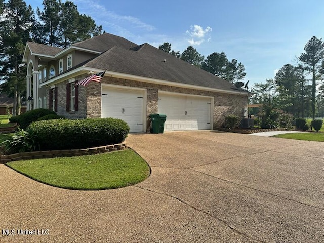 2550 Jones Rd, Terry, MS 39170 - view of property exterior featuring a garage, brick siding, and driveway